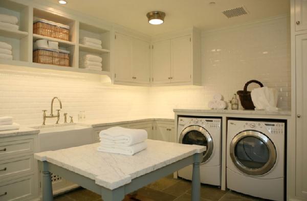 finished laundry room with island and sink