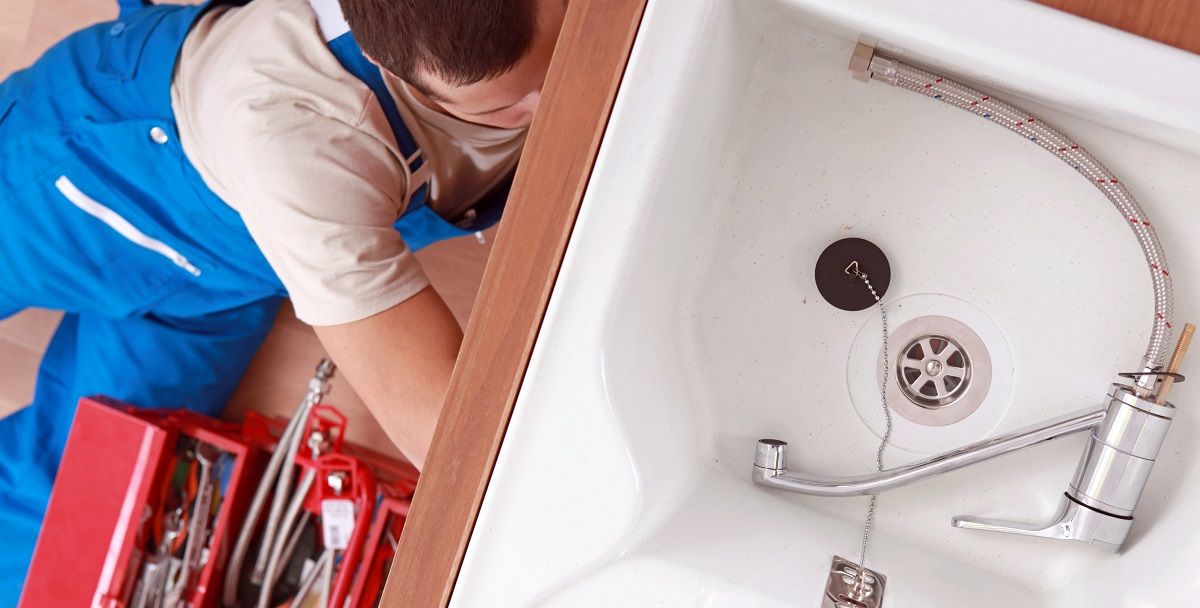 plumber installing kitchen sink