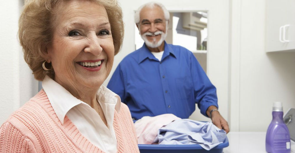 elderly couple doing laundry