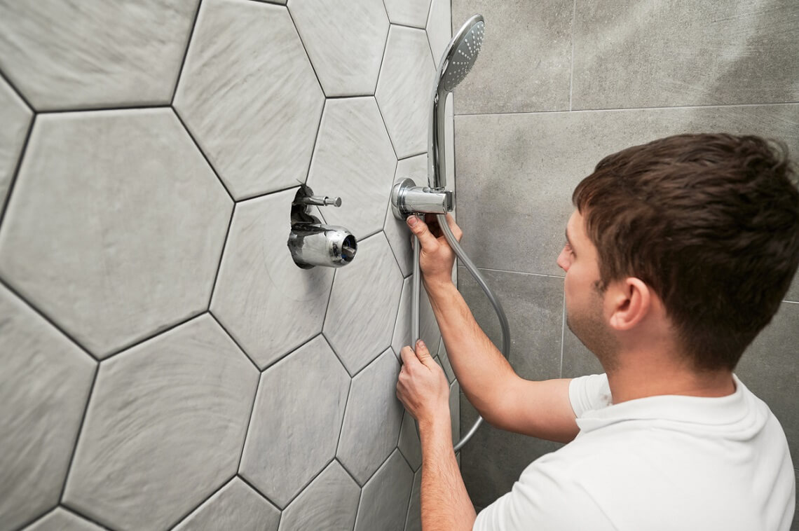 plumber installing shower faucets