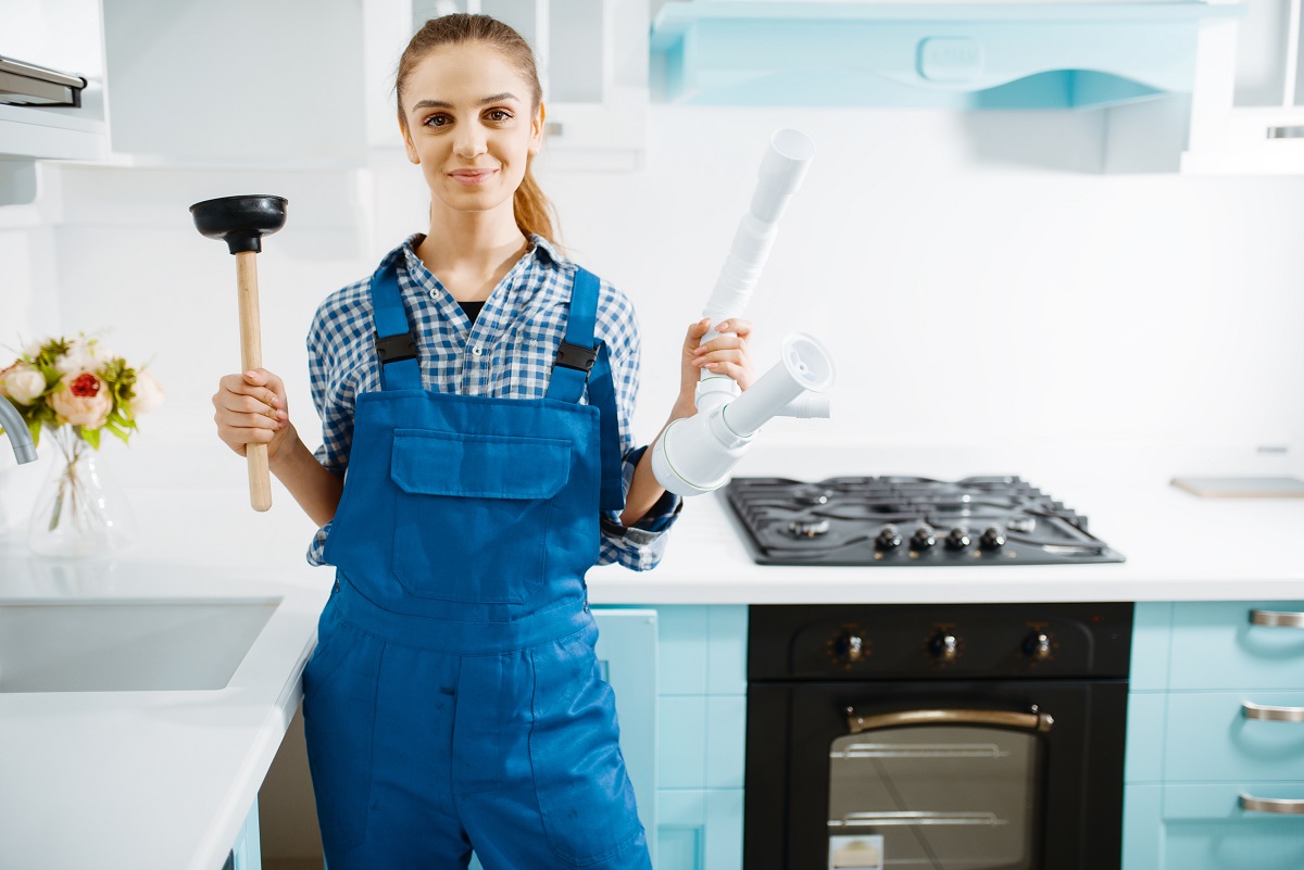 Woman with Plunger at Kitchen Sink